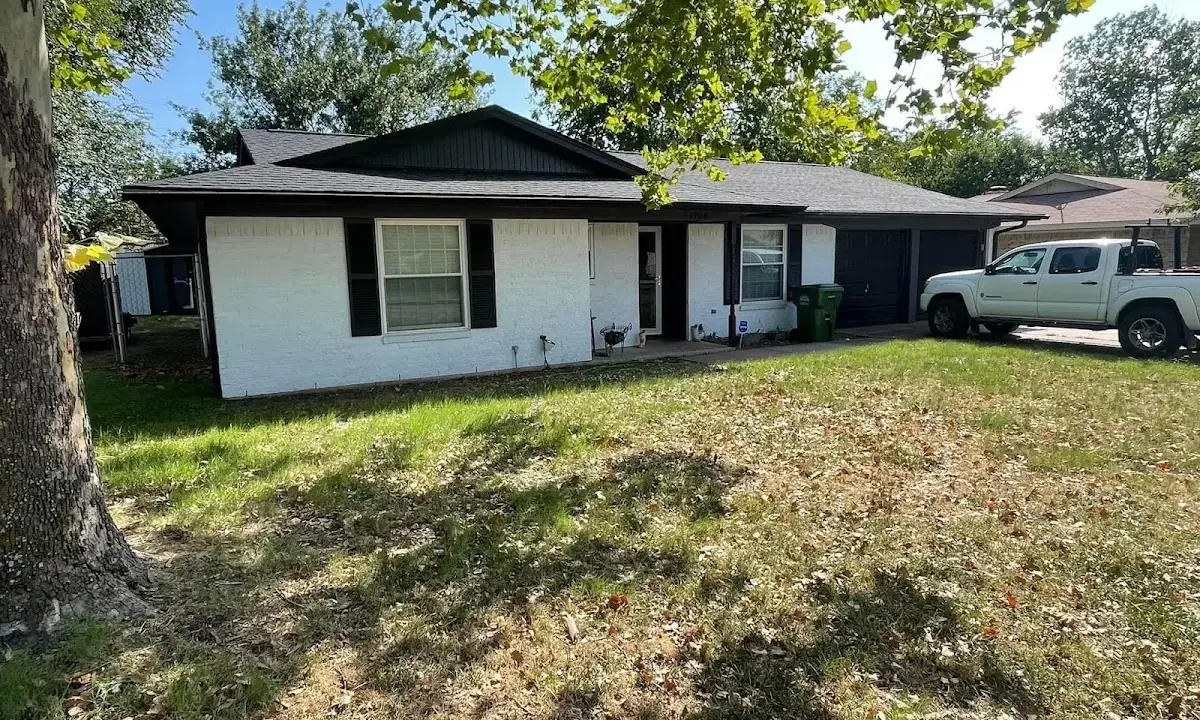 Professional roofing crew working on a residential roof in Wright